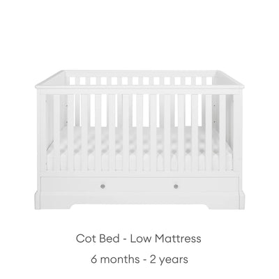 White cot with low mattress height suitable from 6 months - 2 years on a white background