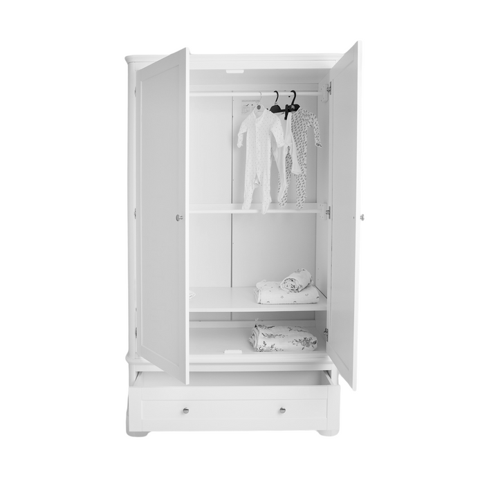 White wardrobe with baby clothes on a white background