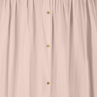 Detail of blush muslin baby canopy with button fastening, soft breathable cotton fabric for nursery décor by Gaia Baby.