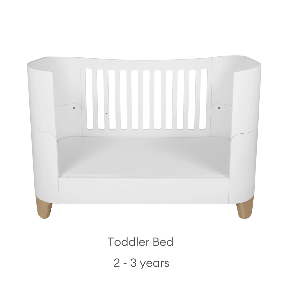 Product image of the Gaia Baby Serena toddler bed with natural oak legs in toddler bed mode, shown on a clean white background with age suitability text indicating use for children aged 2 to 3 years.