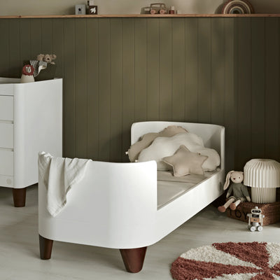 Serena Cot Bed converted to first bed with walnut legs, white kids bed in modern nursery/child bedroom by Gaia Baby.