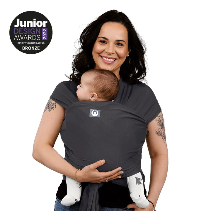 Modelled image of a mother carrying her baby in Junior Design Award 2022 Bronze Winning Gaia Baby Organic Cotton Baby Wrap in graphite colour