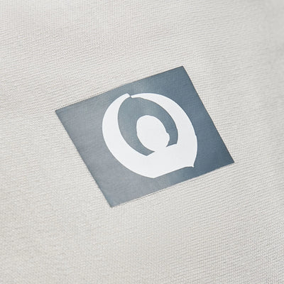 Close-up of Gaia Baby logo on silver grey organic cotton stretchy baby wrap carrier fabric