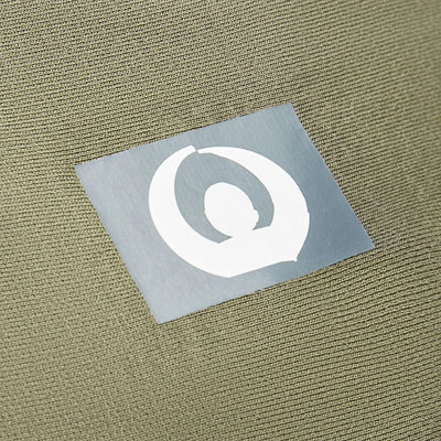 Forest green stretchy baby wrap carrier close-up of logo on fabric.