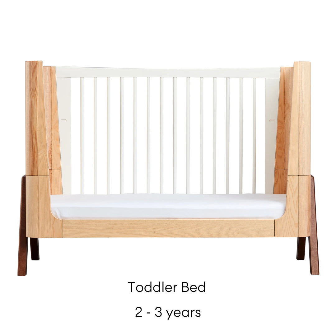 Gaia Baby Hera Convertible Cot Bed product image showing the Toddler Bed mode. One cot side removed to create a bed for an independent toddler