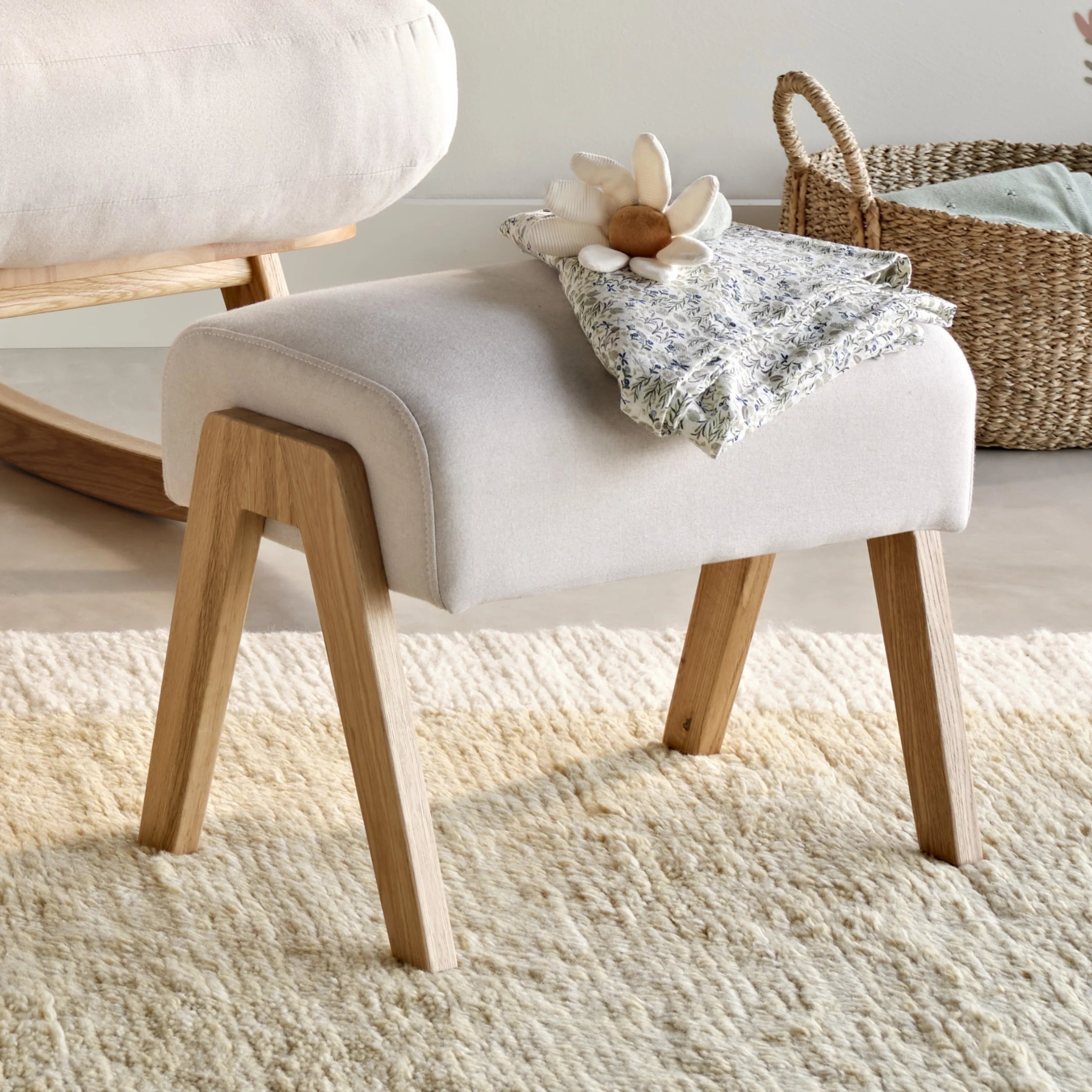 Hera Footstool in Barley colour with wooden legs, upholstered nursery footrest by Gaia Baby with soft neutral styling.