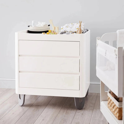 Gaia Baby Serena white dresser styled as a changing station in a nursery setting