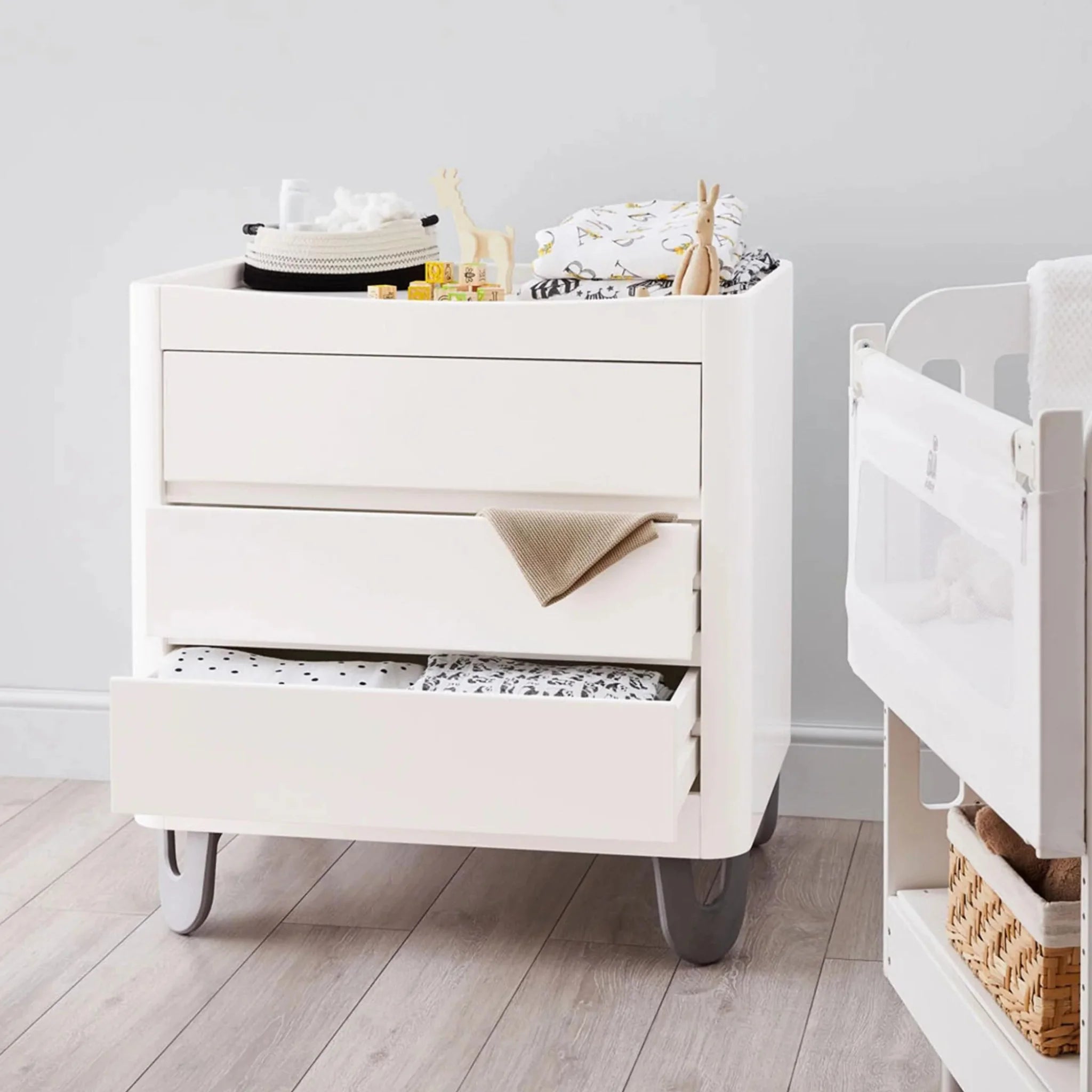 White Gaia Baby Serena dresser with drawers open showing storage and changing tray on top