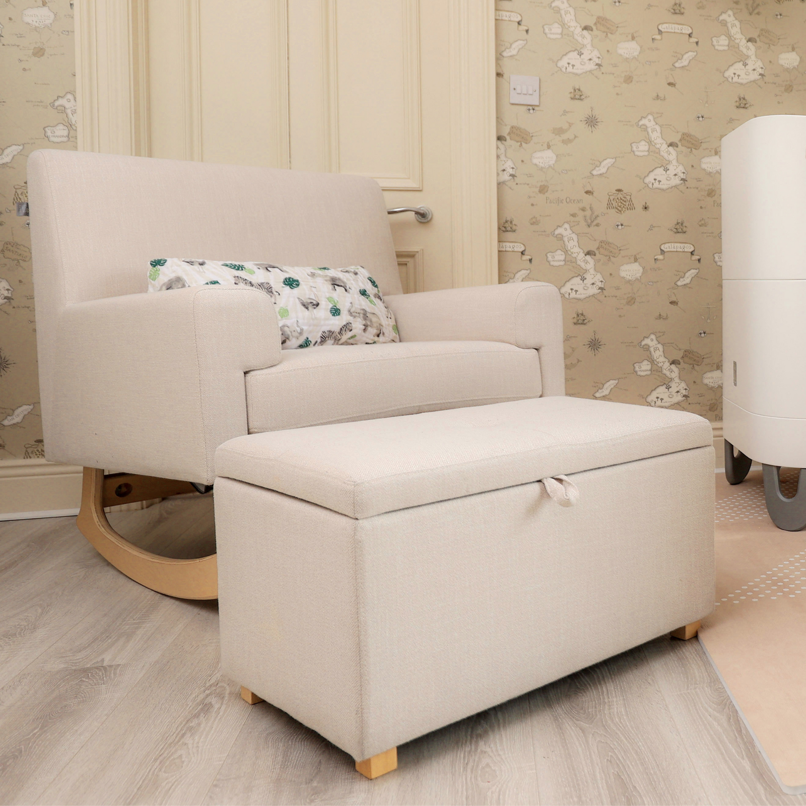 Lifestyle image of a beige Gaia Baby Nursing Chair in colour Oat and a footstool with hidden storage.